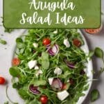 This rustic salad features a base of peppery arugula leaves, complemented by sweet cherry tomatoes, and feta cheese.