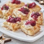 Holiday appetizers with cranberry sauce, brie cheese and thyme