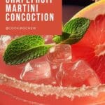 A close-up photo of a vibrant pink cocktail in a coupe glass, garnished with a grapefruit slice and a sprig of mint.