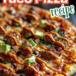 A delicious homemade taco pizza topped with ground beef, lettuce, tomatoes, cheese, and a crispy crust.