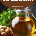A close-up photo of a glass bottle of peanut oil and a bowl of peanuts on a wooden table.