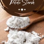 A wooden spoon scooping up a heaping mound of potato starch.