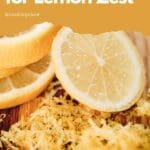 A pile of freshly grated citrus peel on a wooden cutting board.