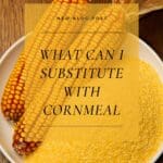 An image of a bowl of golden cornmeal on a wooden table.