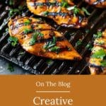 A closeup of grilled chicken fillets on an iron grill, marinated in a lemon and honey glaze with fresh herbs for coloring.