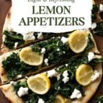 A flatbread bread topped with kale, goat cheese, and lemon slices, served on a white plate.