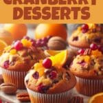 A close-up image of cranberry, orange and pecan muffins on a wooden board.