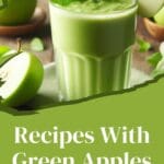A glass of green apple smoothie with a slice of green apple on top.