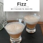 Two glasses of Cranberry Gin Fizz on a black board.