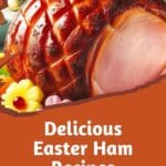 A delicious Easter ham glazed with pineapple slices and flowers on a plate.