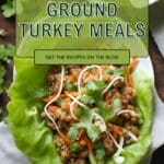 A close-up photo of a ground turkey lettuce wrap on a dark slate plate.