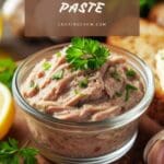 A close-up photo of a bowl of anchovy paste on a wooden table.