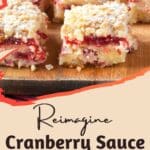 A close-up photo of a rustic wooden cutting board adorned with a glistening ruby red jewel – cranberry sauce.