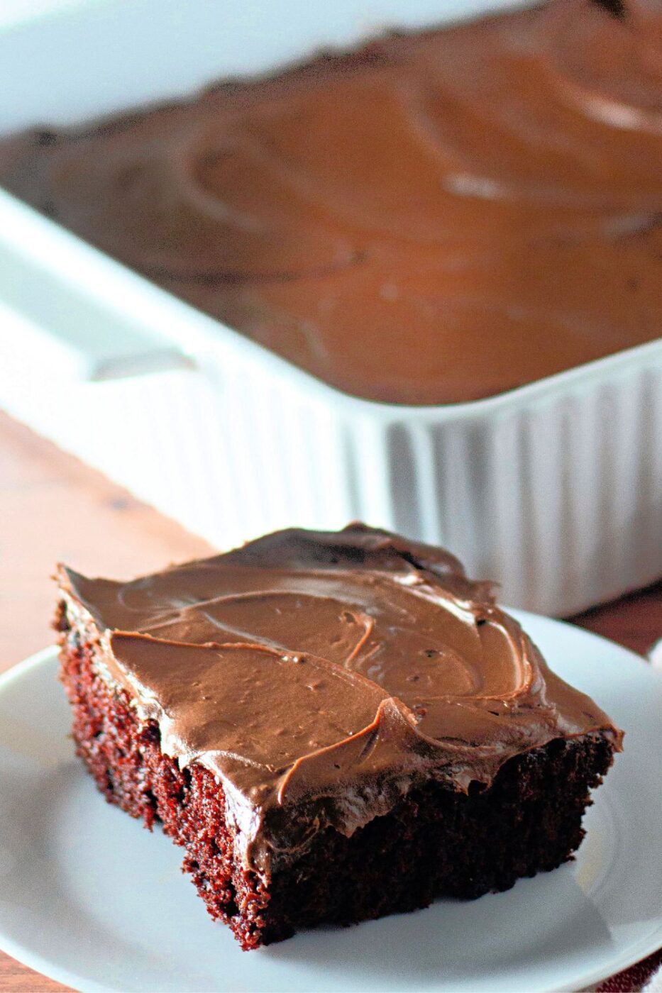 A slice of moist chocolate crazy cake, possibly with a dusting of powdered sugar.