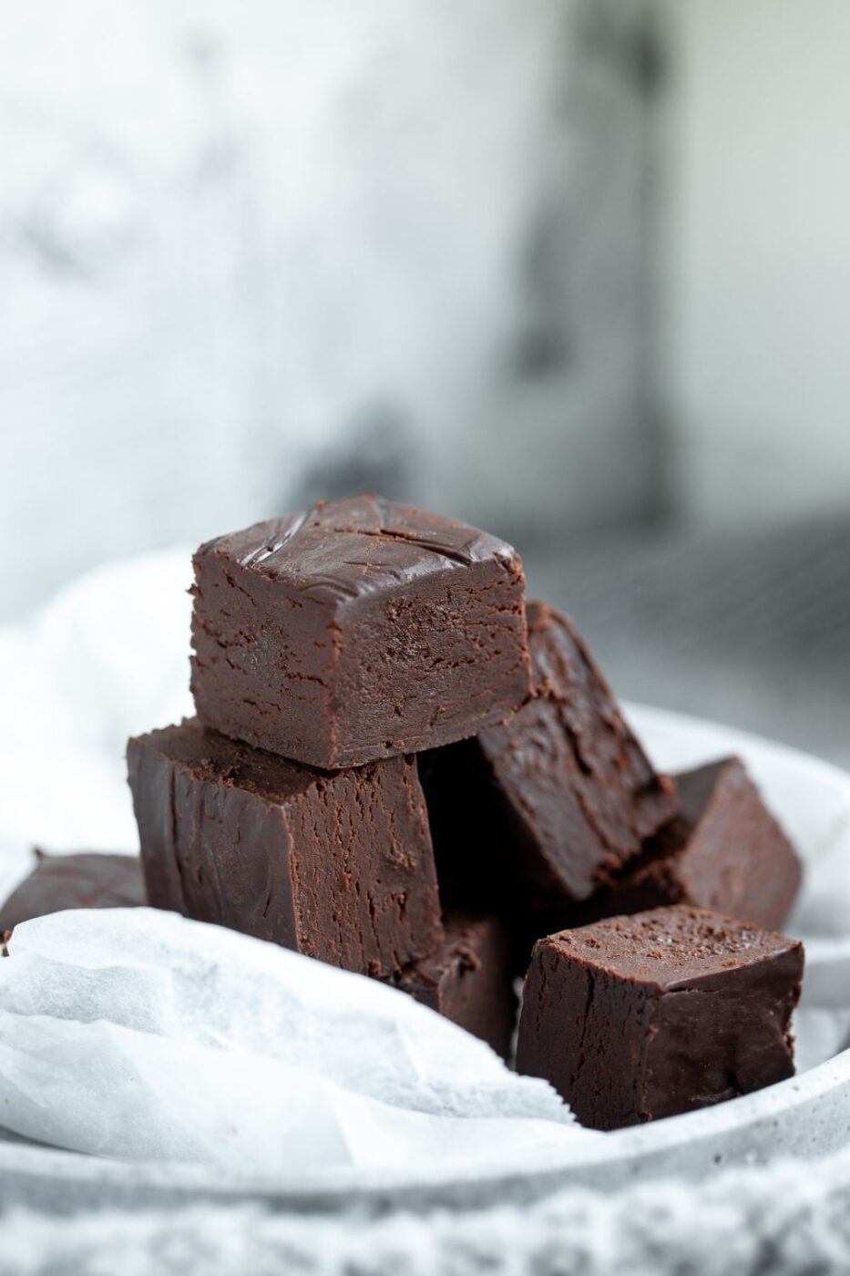 A tray of rich, dark fantasy fudge squares, possibly with walnuts or chocolate chips.