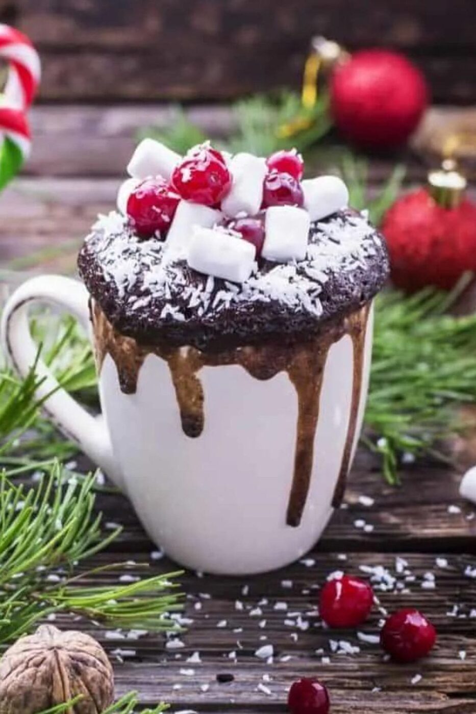 A rich, dark keto chocolate mug cake with a spoon, showing its moist texture.