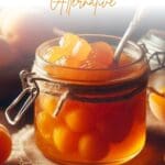 A glass jar filled with golden apricot preserves sits on a rustic wooden table.