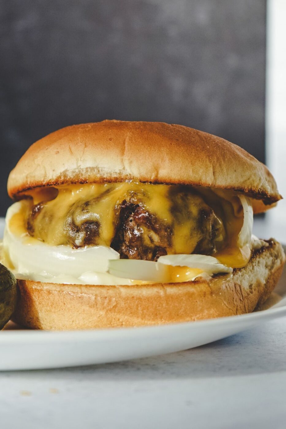 A perfectly cooked air fryer hamburger on a bun with toppings.