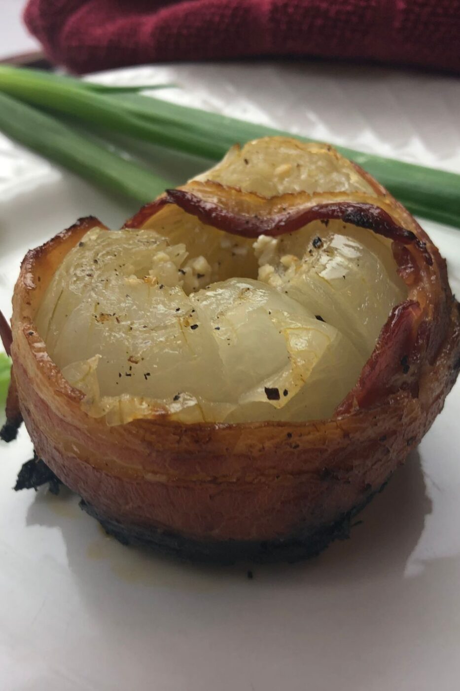 Whole roasted Vidalia onions topped with crispy bacon and roasted garlic cloves.