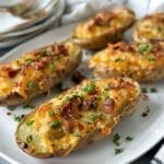 A plate heaped with five twice-baked fingerling potatoes.