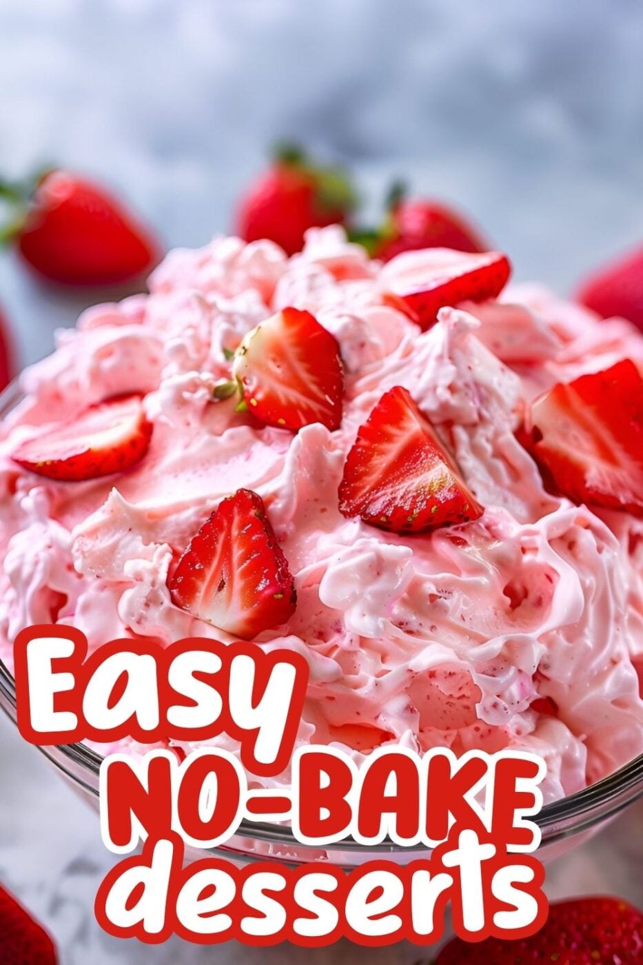 Creamy pink fluff with lots of sliced strawberries, a dessert made with whipped topping, strawberry gelatin and crushed pineapple.