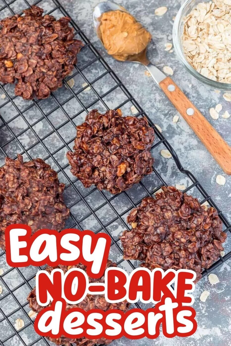 Classic no bake cookies on a cooling rack, made with melted chocolate, peanut butter and oats sitting next to a wood-handled spoon with a bit of peanut butter on the end
