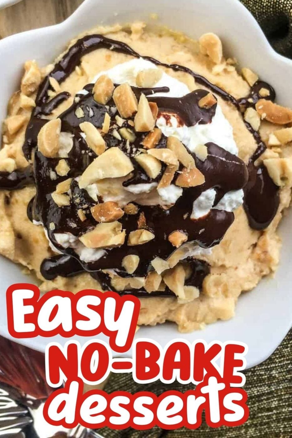 Close up of a dish containing a mound of peanut butter mousse parfait with a spritz of whipped cream, chopped peanuts and a heavy drizzle of chocolate sauce