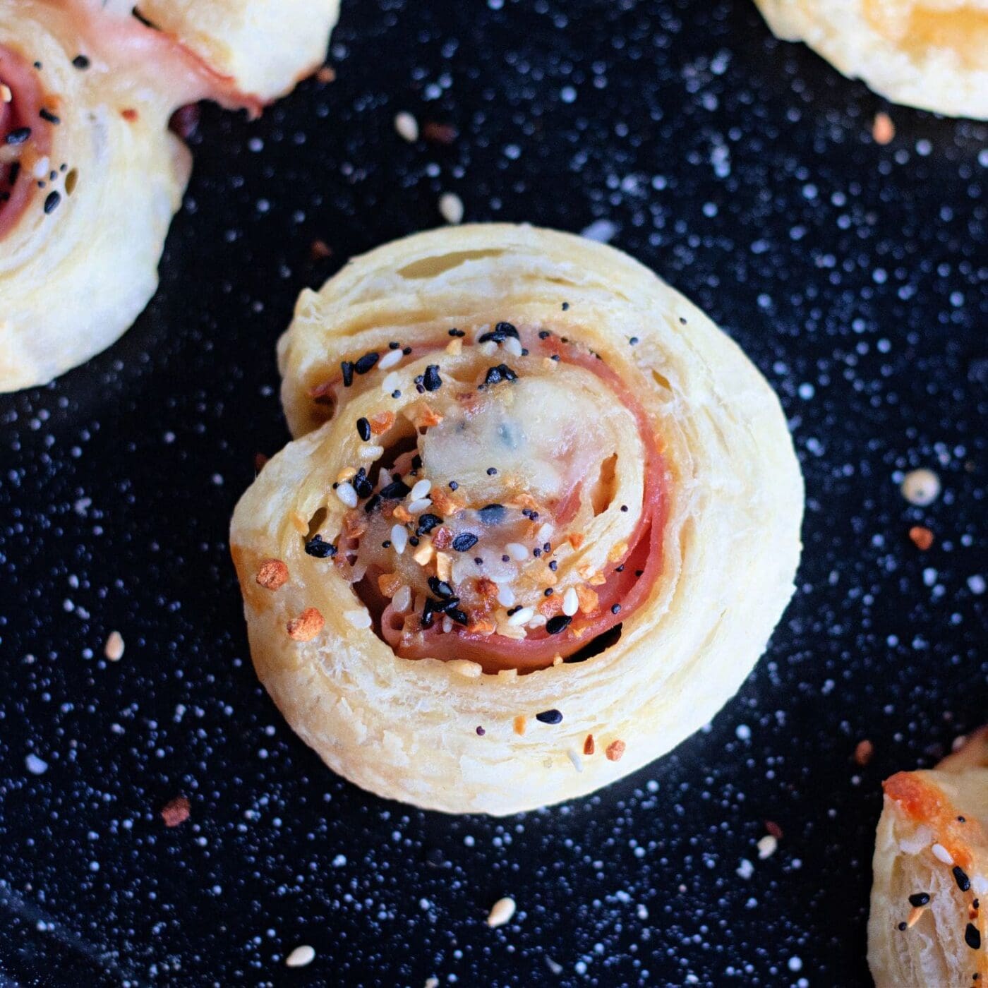 Ham and cheese pinwheels with buttery puff pastry, baked to perfection.