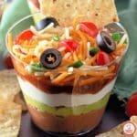 No-cook layered dip cups with vibrant Tex-Mex ingredients.