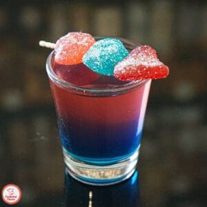 Close-up of beautifully layered Jolly Rancher shots with red, blue, and green colors