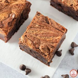 A close-up of a gooey peanut butter brownie being pulled apart.
