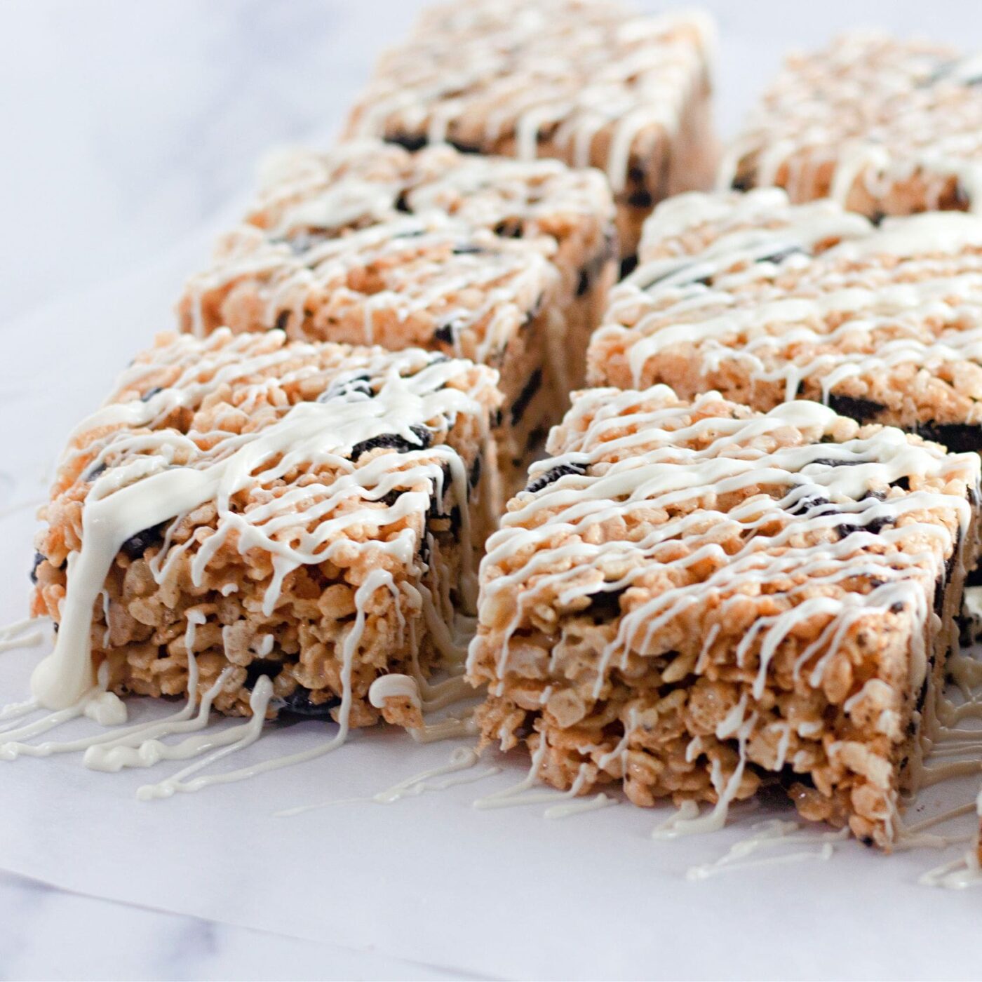 Stack of gooey Oreo rice krispie treats with creamy marshmallow pull.