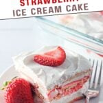 Layers of strawberry shortcake ice cream cake garnished with whipped cream.​