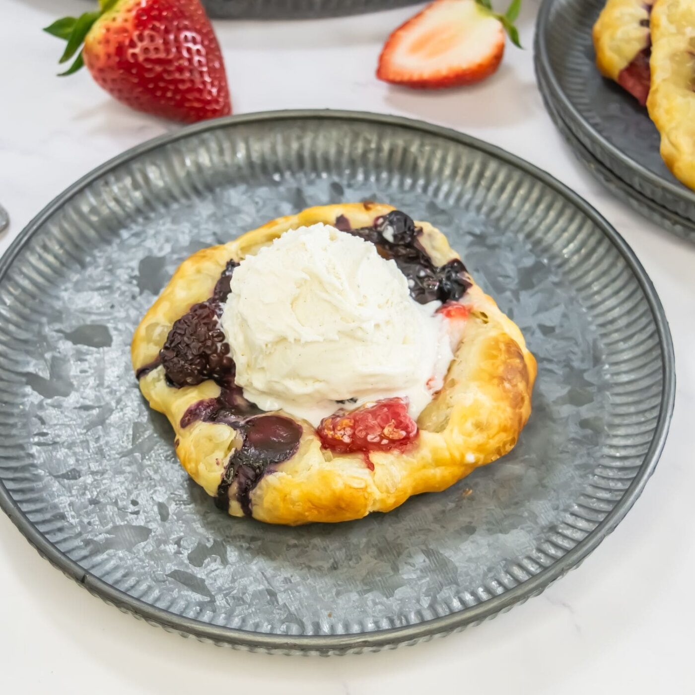 A vibrant, large image of flaky mixed berry pastries.