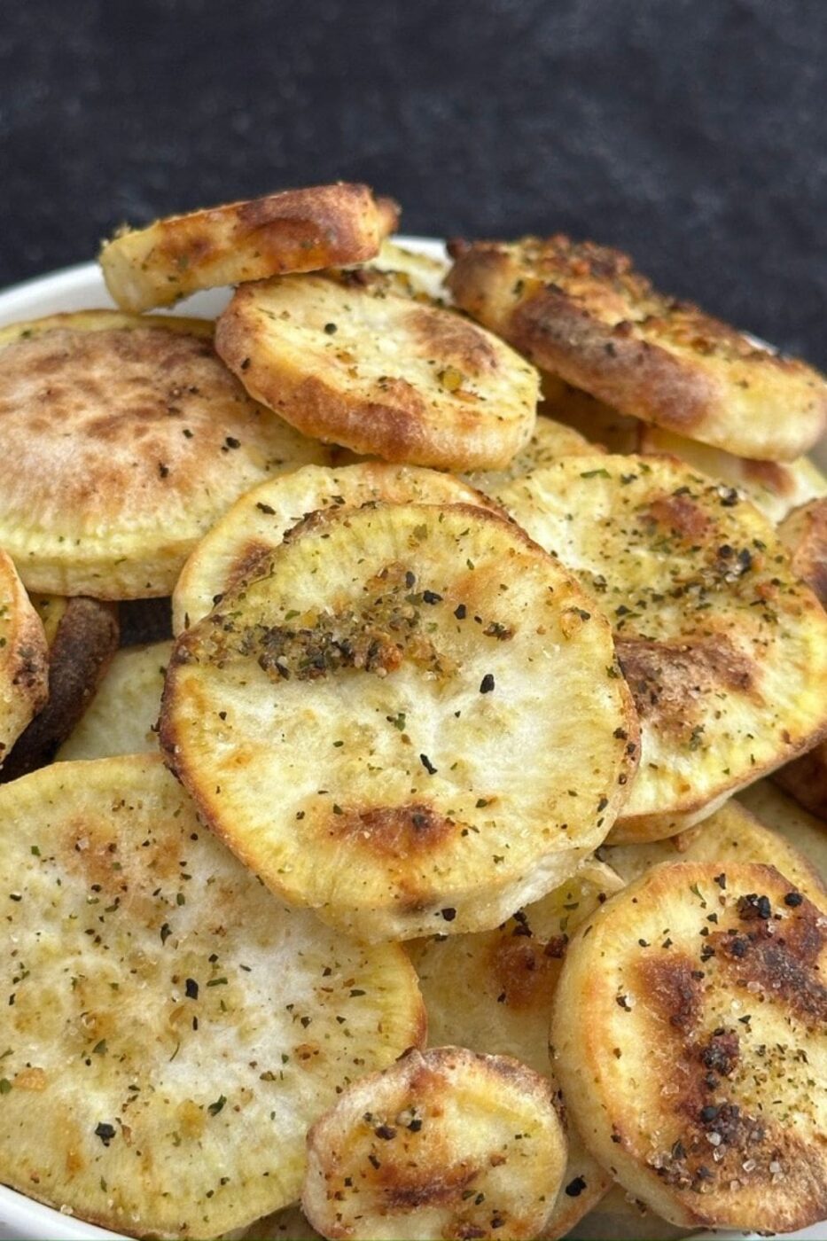 Golden brown and crispy sweet potato rounds arranged on a plate.