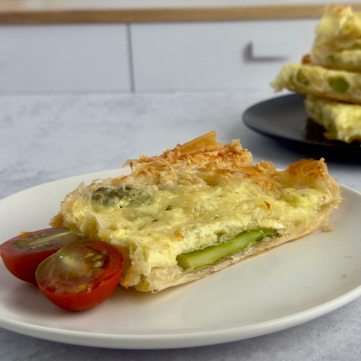 A slice of golden cheesy asparagus phyllo tart