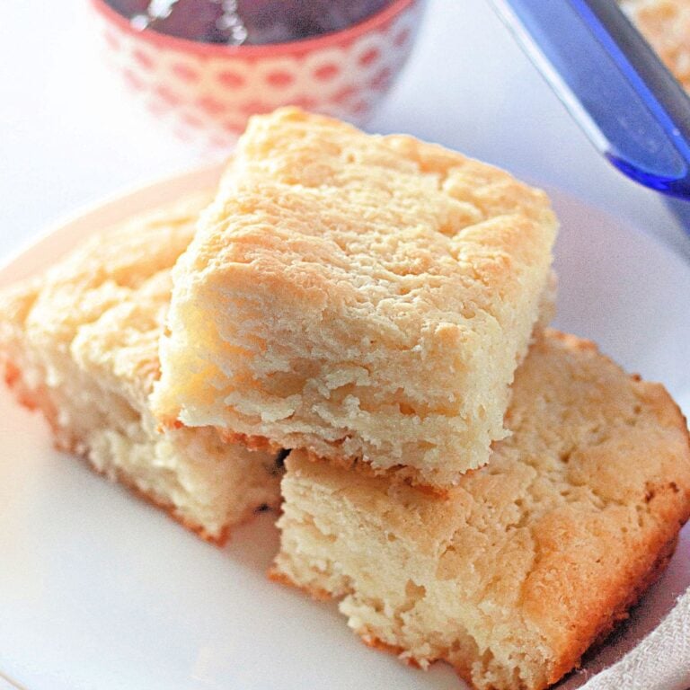 A wide, inviting shot of a full pan of golden-brown butter dip biscuits.