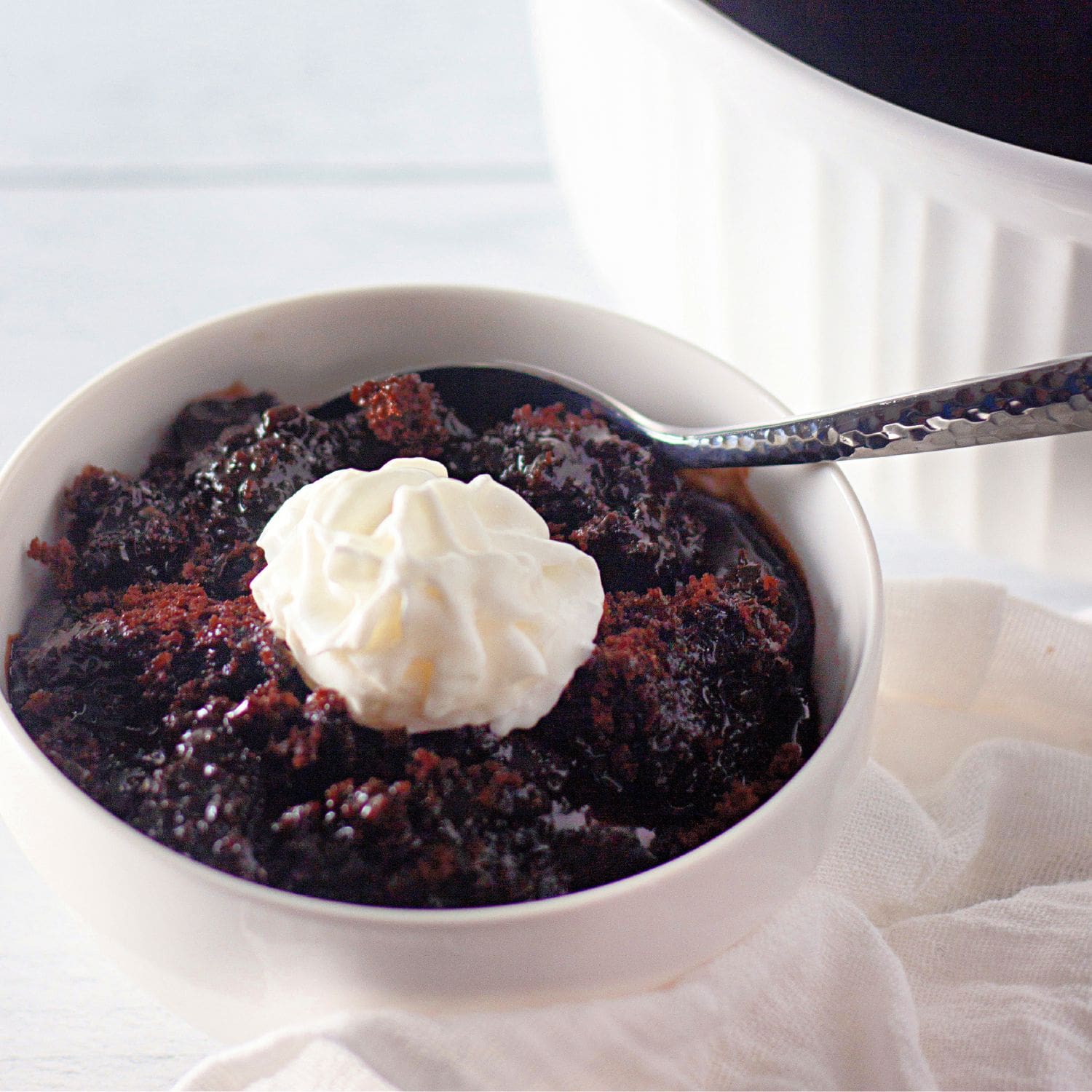 A large, inviting photo of a rich chocolate lava cake with a gooey center, possibly topped with ice cream.