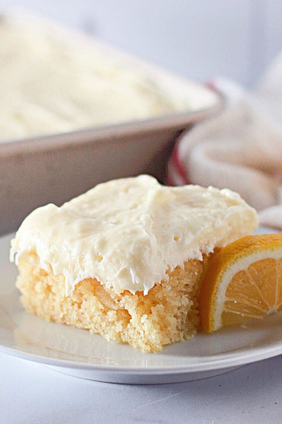 Sliced lemon crazy cake with light glaze and lemon zest.