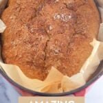 A golden-brown loaf of no-knead bread baked in a Dutch oven, with a crispy crust.