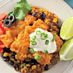A clear, detailed image of a slice of enchilada tater tot casserole on a plate.
