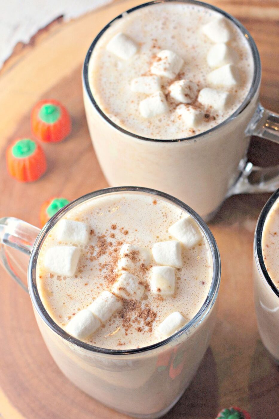 A mug of pumpkin white hot chocolate with whipped cream and cinnamon.