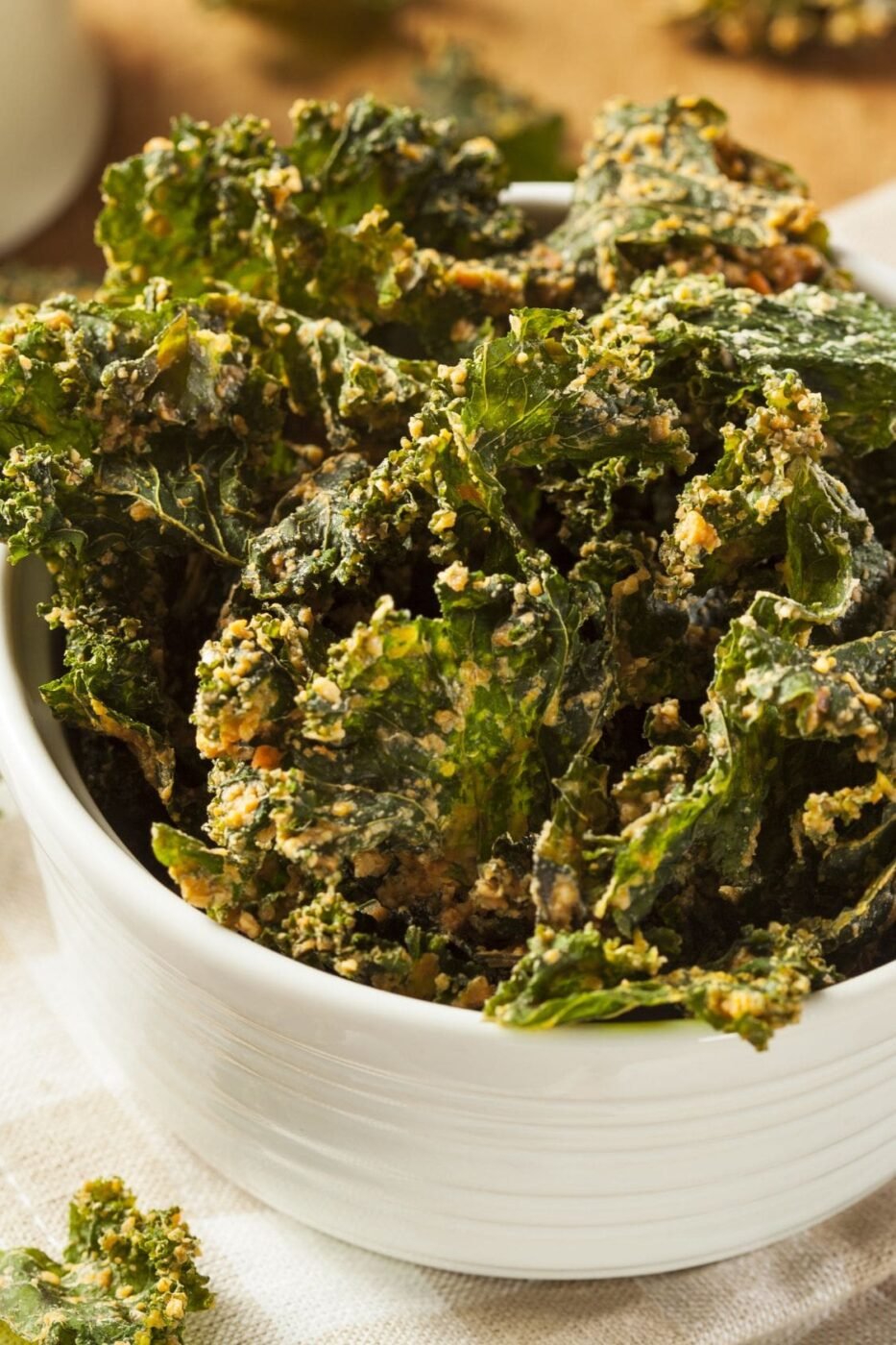 A bowl of seasoned kale chips ready for snacking.