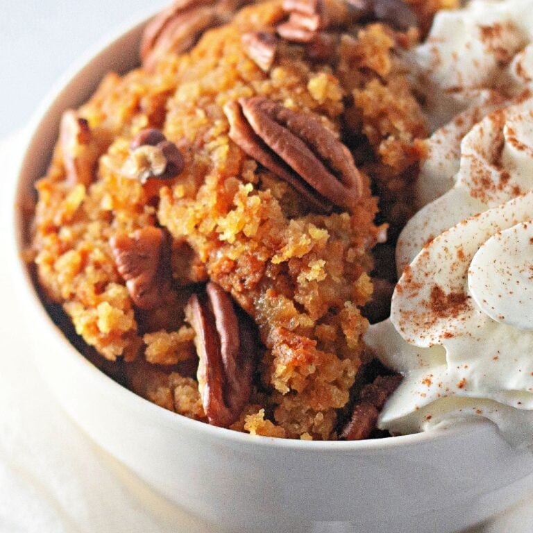 Hero shot of crockpot pumpkin cobbler baked in a slow cooker with pecans.