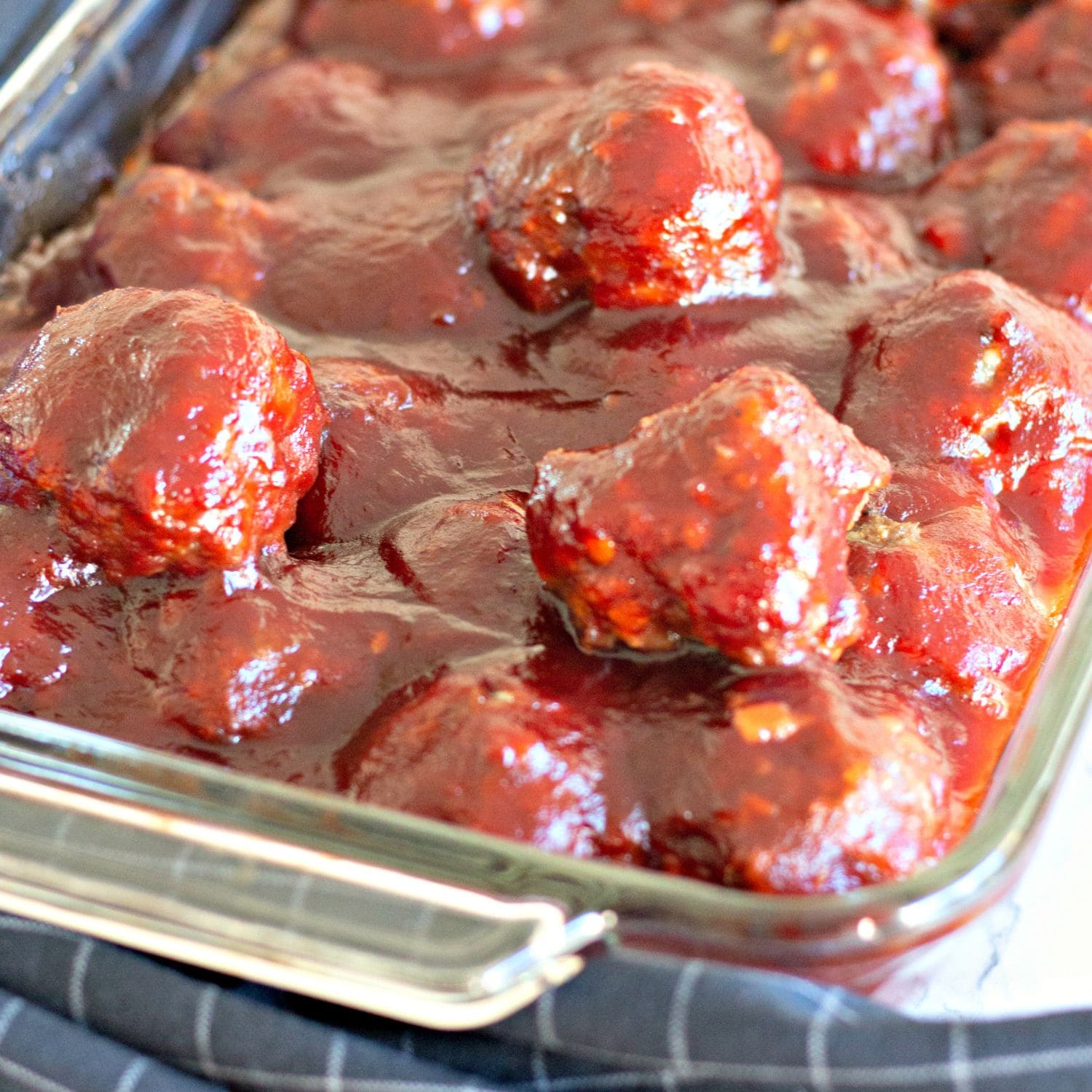 Featured image of cranberry BBQ meatballs with parsley garnish.