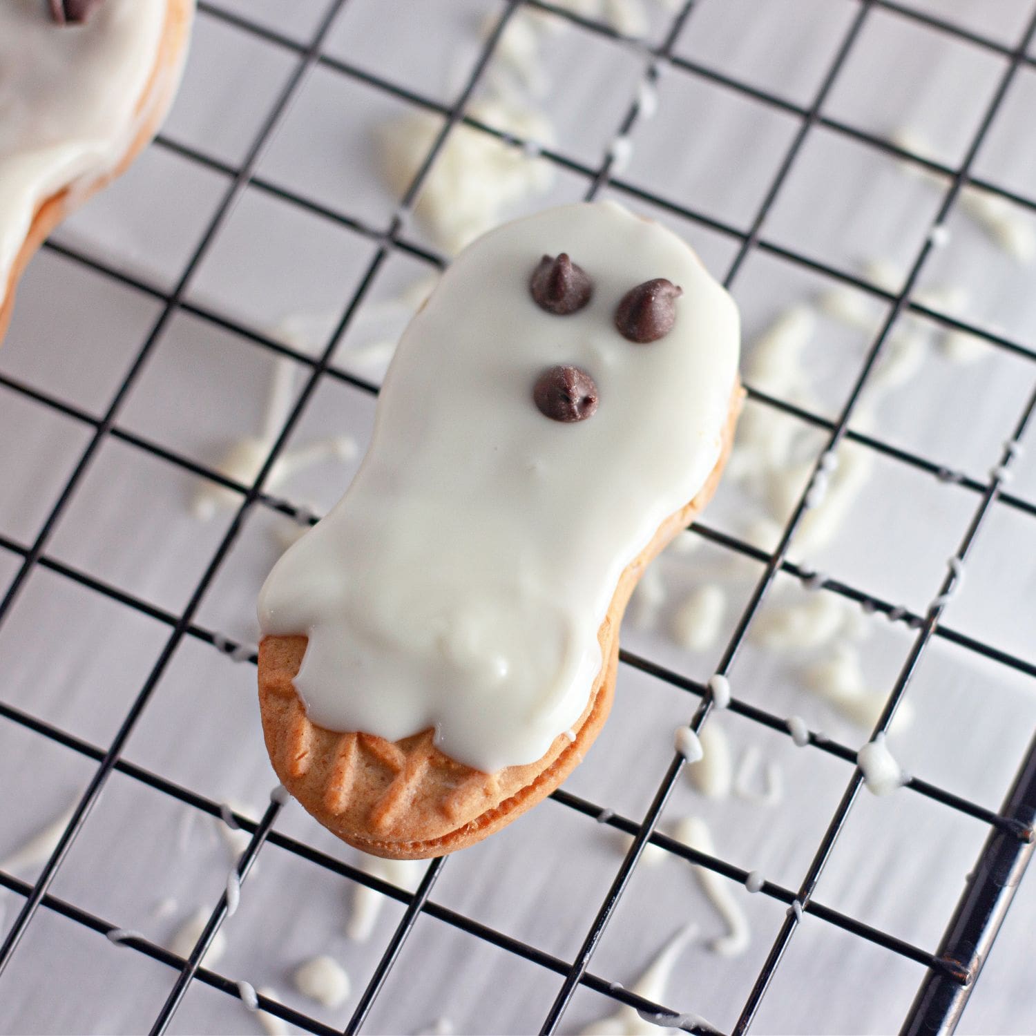 Styled recipe card image showing mummy and ghost cookies on a platter.