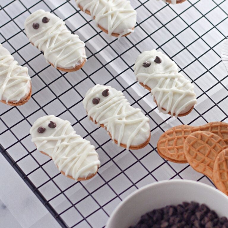 Hero image of assorted white chocolate dipped Halloween cookies on a serving tray.