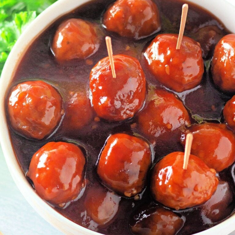 Bowl of honey garlic meatballs coated in sweet and savory brown sugar glaze.