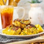 Golden brown chicken meatballs on lemon orzo pasta with parsley garnish.