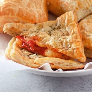 Recipe card image of golden pizza pockets with a cheesy, saucy filling.